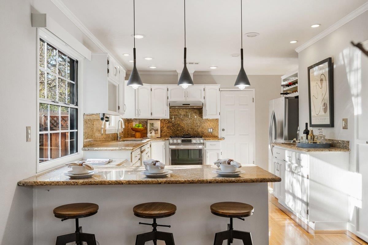 1277 Edgewood Road Redwood City, CA 94062 - Photo 22 of 49 a kitchen with counter space and chairs in it