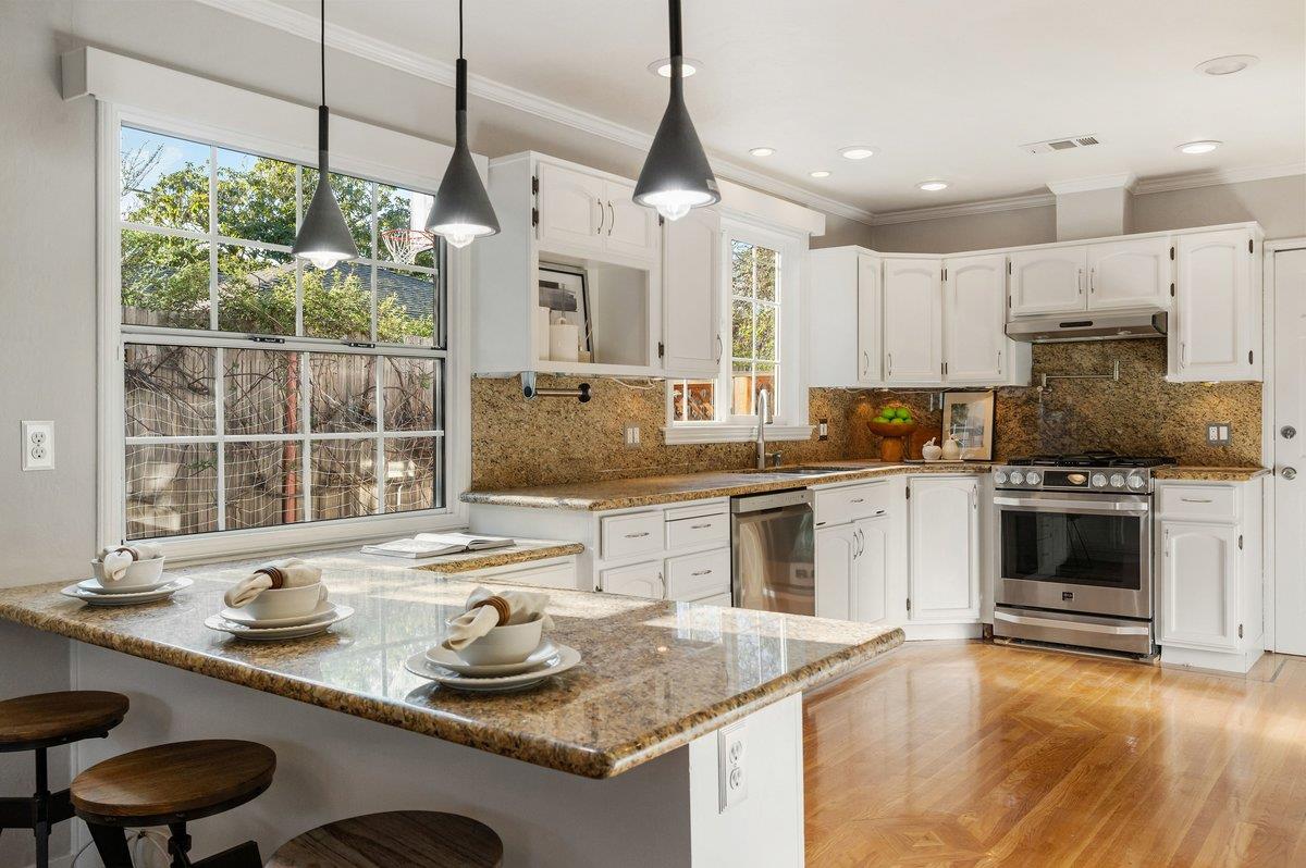 1277 Edgewood Road Redwood City, CA 94062 - Photo 24 of 49 a kitchen with stainless steel appliances granite countertop a sink and cabinets