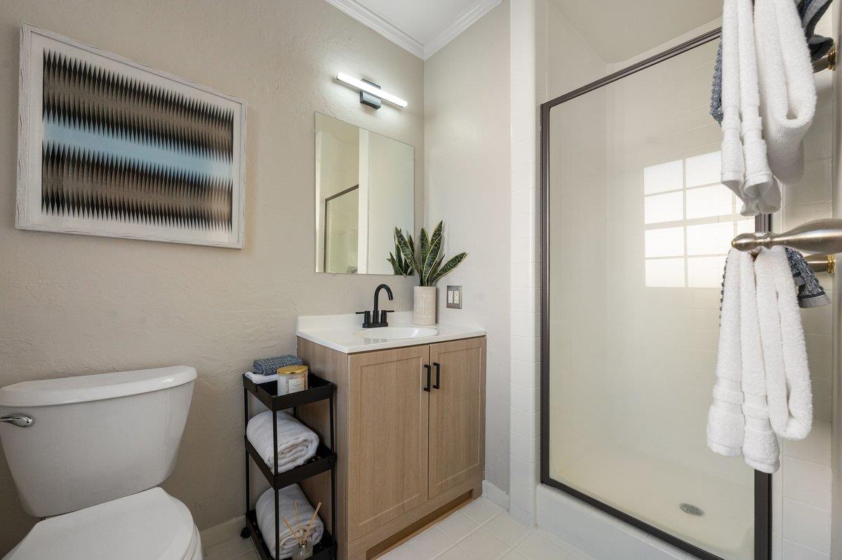 1277 Edgewood Road Redwood City, CA 94062 - Photo 31 of 49 a bathroom with a toilet sink and shower