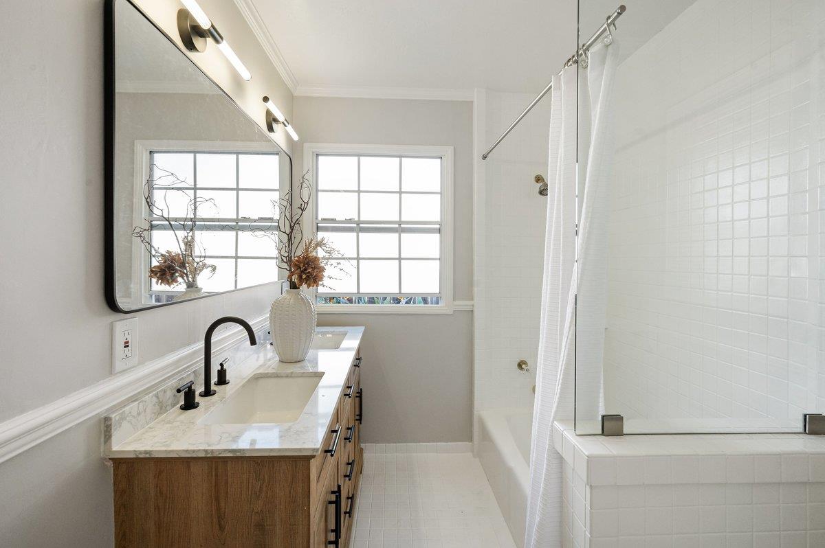 1277 Edgewood Road Redwood City, CA 94062 - Photo 35 of 49 a bathroom with a sink a mirror and a window