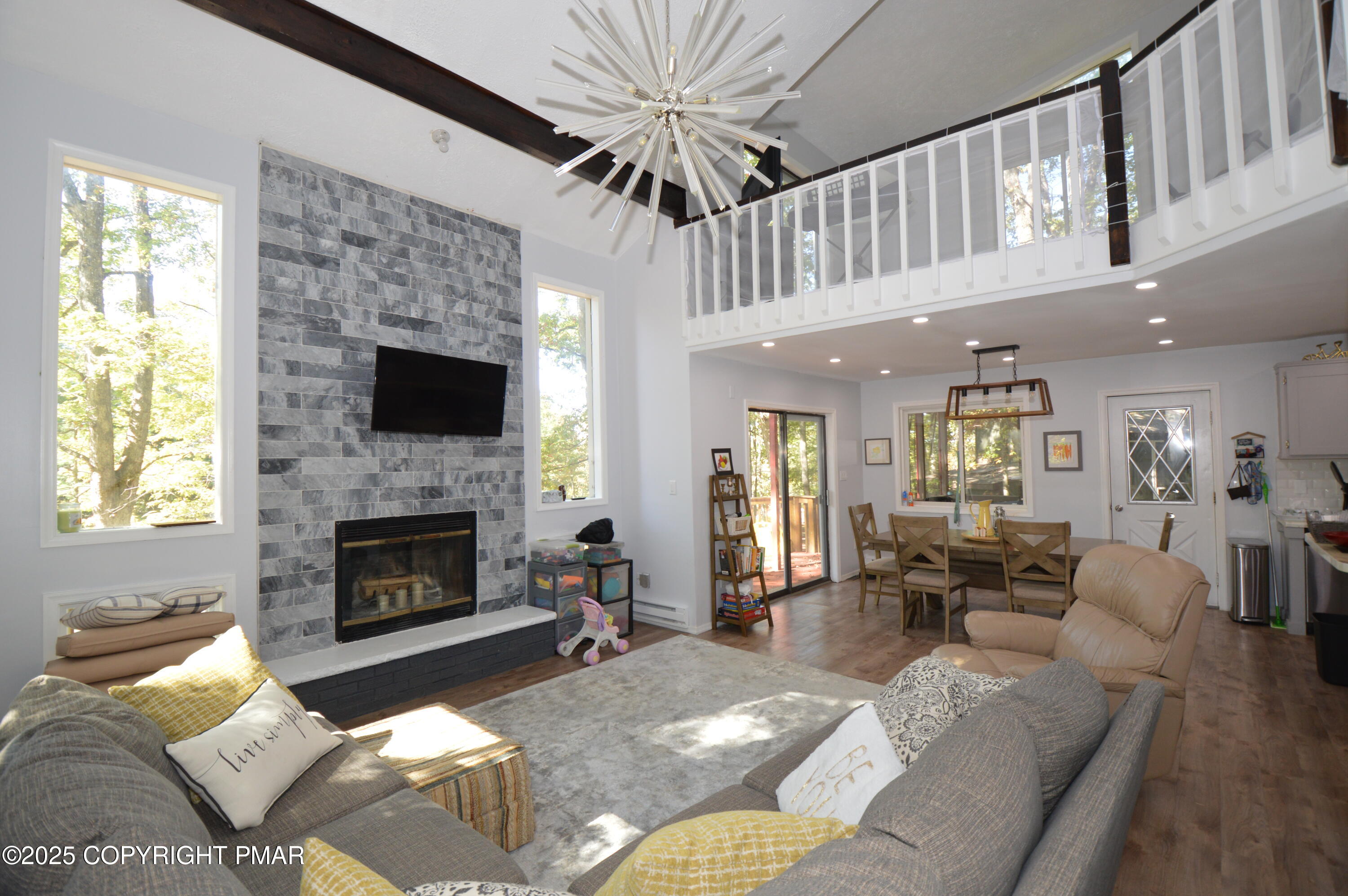 128 Ashley Court Bushkill, PA 18324 - Photo 23 of 43 a living room with furniture a fireplace and a flat screen tv