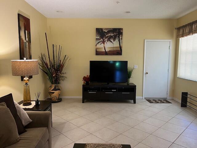 106 Lighthouse Circle, Unit G Tequesta, FL 33469 - Photo 11 of 35 a living room with furniture and a flat screen tv