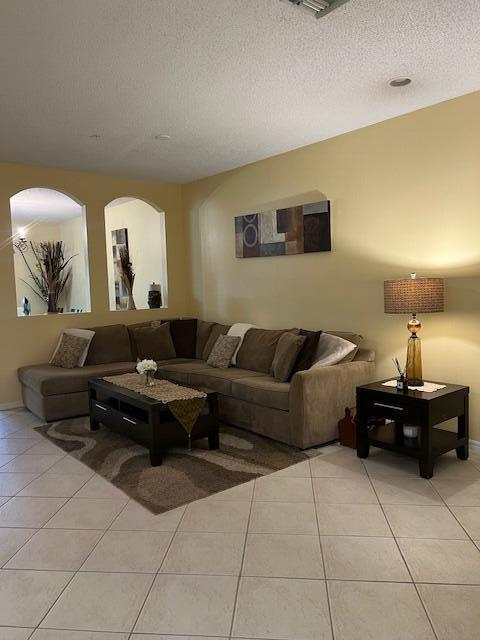 106 Lighthouse Circle, Unit G Tequesta, FL 33469 - Photo 13 of 35 a living room with furniture and a mirror