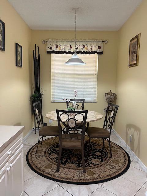 106 Lighthouse Circle, Unit G Tequesta, FL 33469 - Photo 20 of 35 a view of a dining room with furniture and window