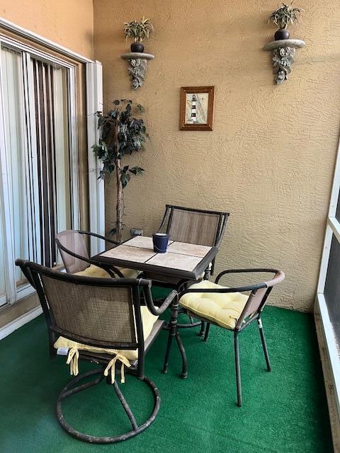 106 Lighthouse Circle, Unit G Tequesta, FL 33469 - Photo 33 of 35 a dining room with furniture and wooden floor