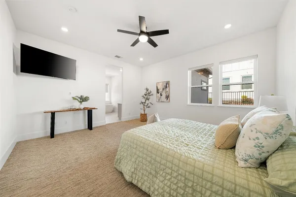 a living room with furniture a rug and a flat screen tv