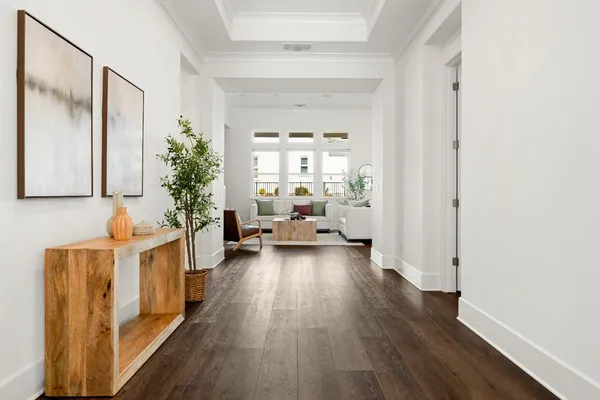 a living room with stainless steel appliances furniture and a view of kitchen