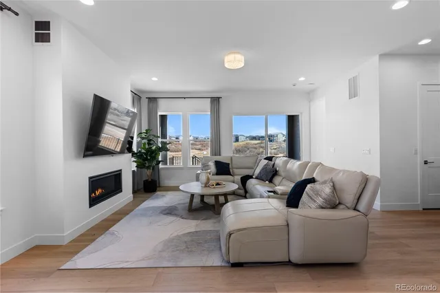 a living room with fireplace furniture and a flat screen tv