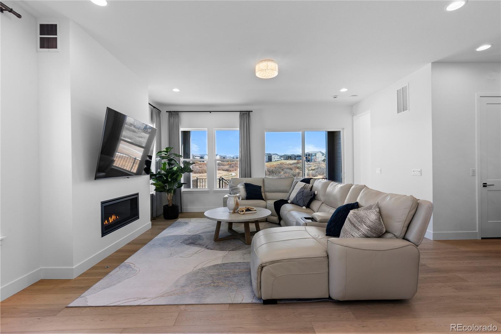 6610 Fawn Path Lane Castle Pines, CO 80108 - Photo 12 of 50 a living room with furniture flat screen tv and a fireplace