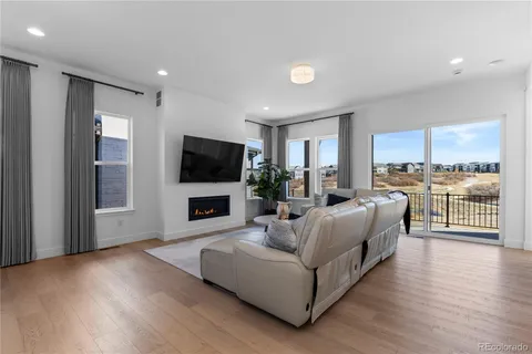 a living room with furniture and view of kitchen