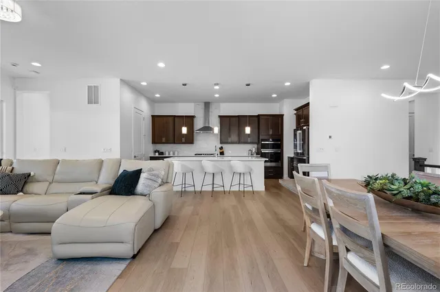 a large kitchen with a table and chairs