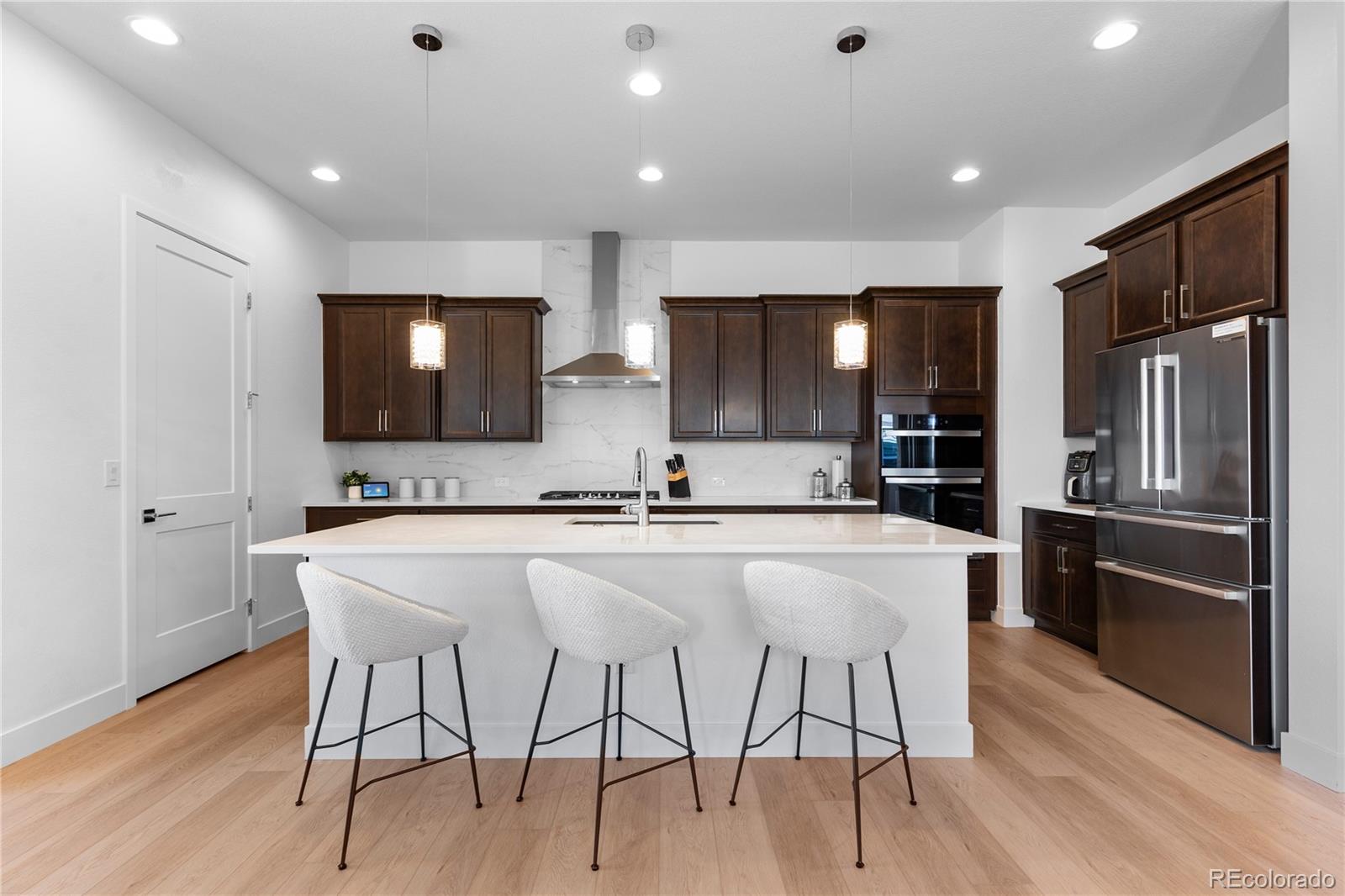 6610 Fawn Path Lane Castle Pines, CO 80108 - Photo 15 of 50 a large kitchen with a table and chairs