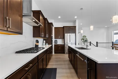 a kitchen with counter top space sink and refrigerator