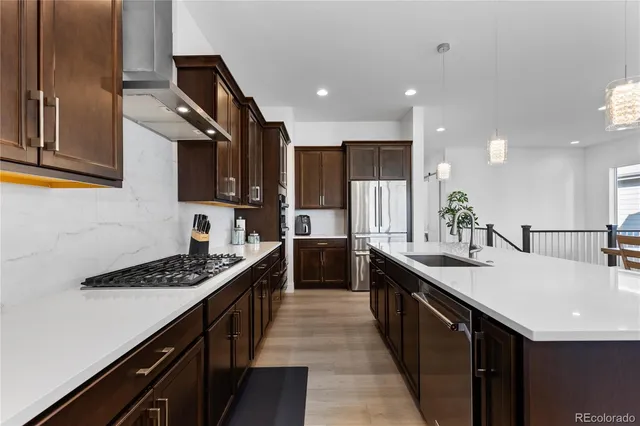 a kitchen with counter top space sink and refrigerator
