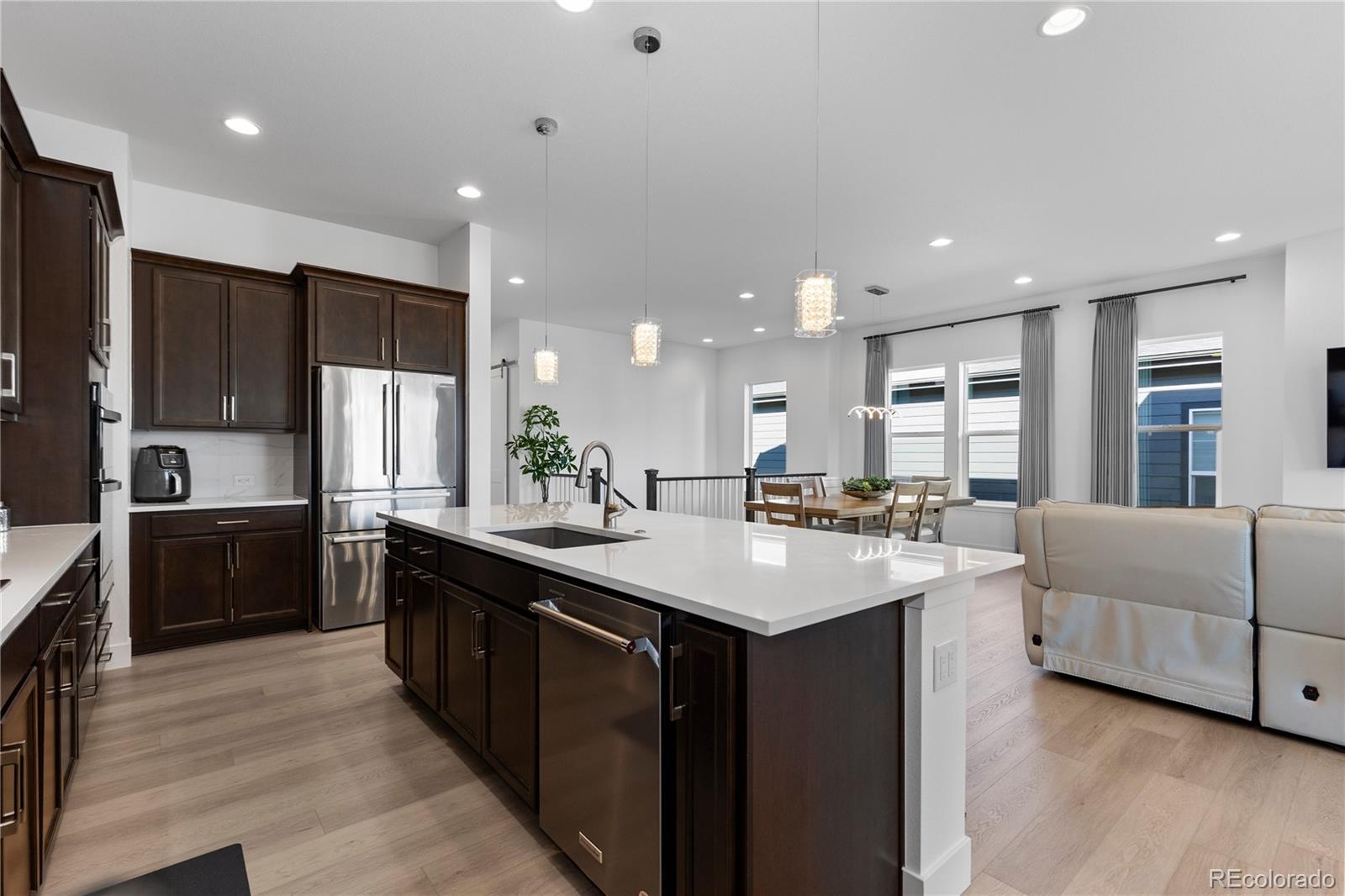 6610 Fawn Path Lane Castle Pines, CO 80108 - Photo 19 of 50 a kitchen with counter top space sink and refrigerator