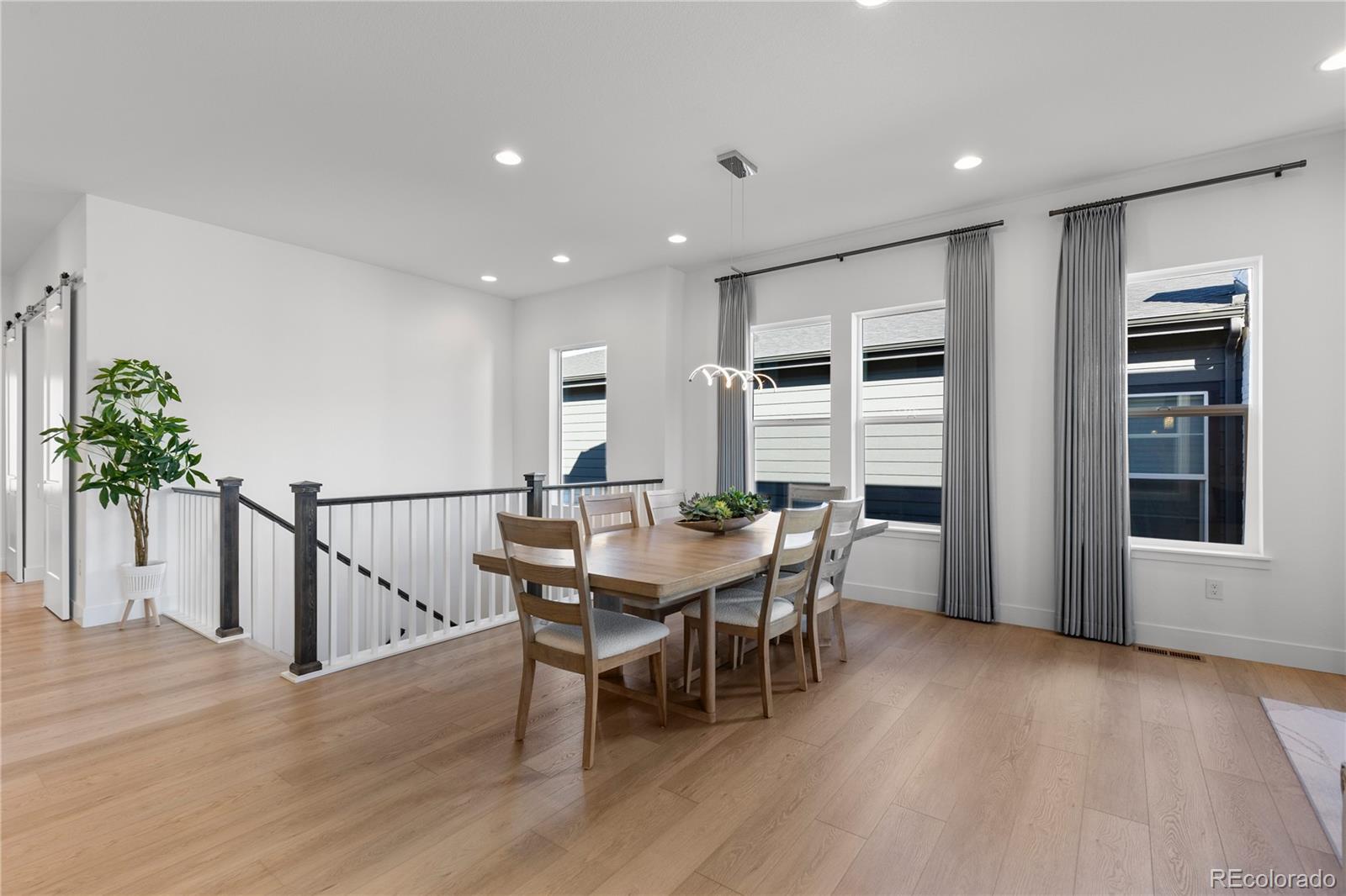 6610 Fawn Path Lane Castle Pines, CO 80108 - Photo 20 of 50 a view of a dining room with furniture and wooden floor