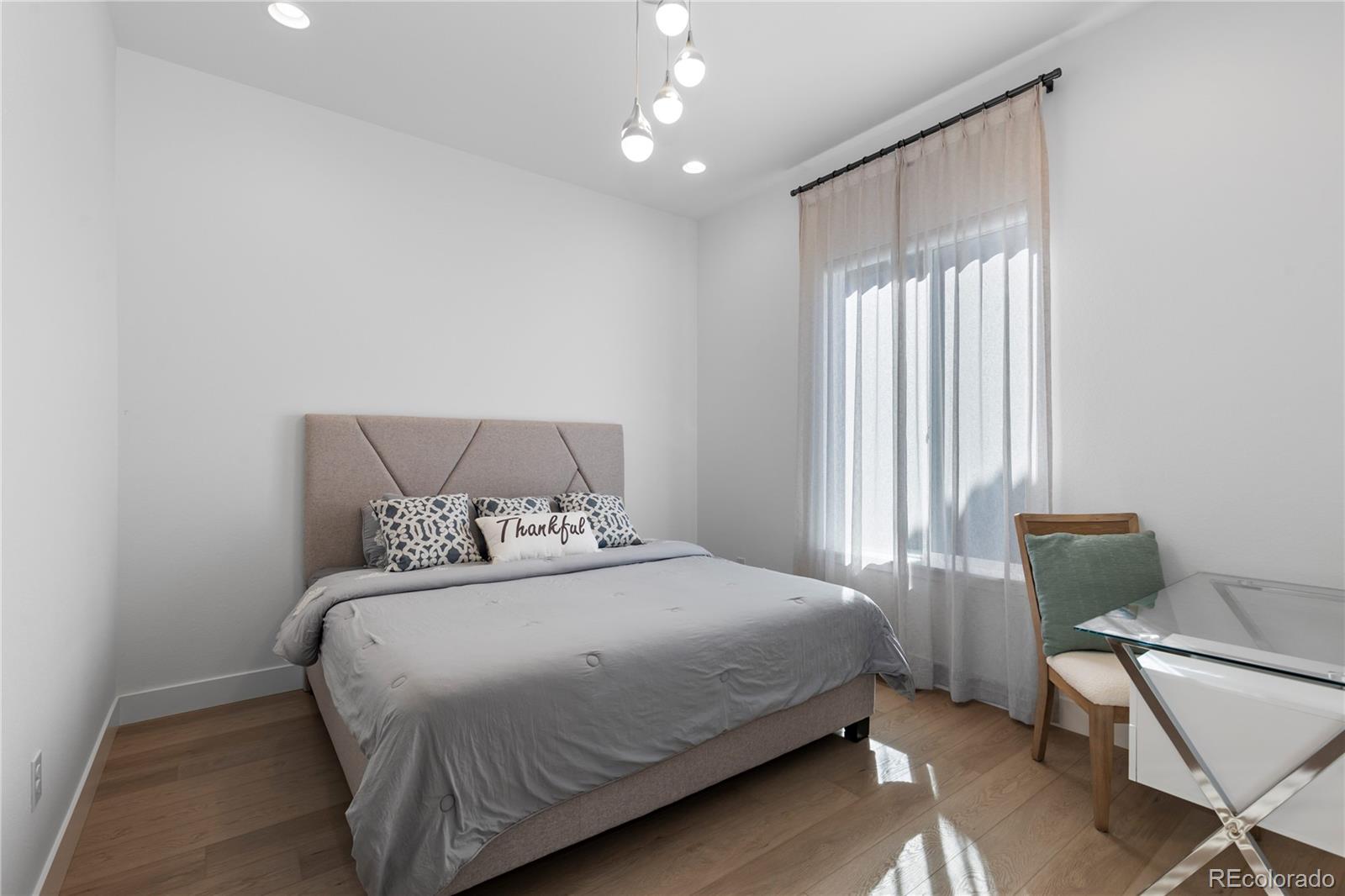 6610 Fawn Path Lane Castle Pines, CO 80108 - Photo 24 of 50 a bedroom with a bed and chair