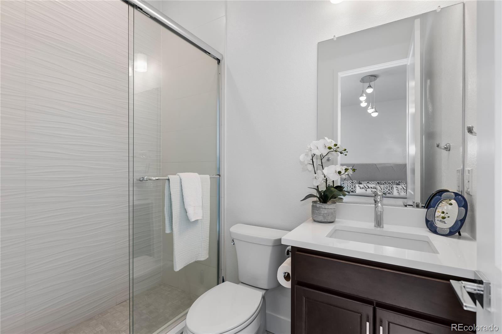 6610 Fawn Path Lane Castle Pines, CO 80108 - Photo 25 of 50 a bathroom with a sink a toilet and shower