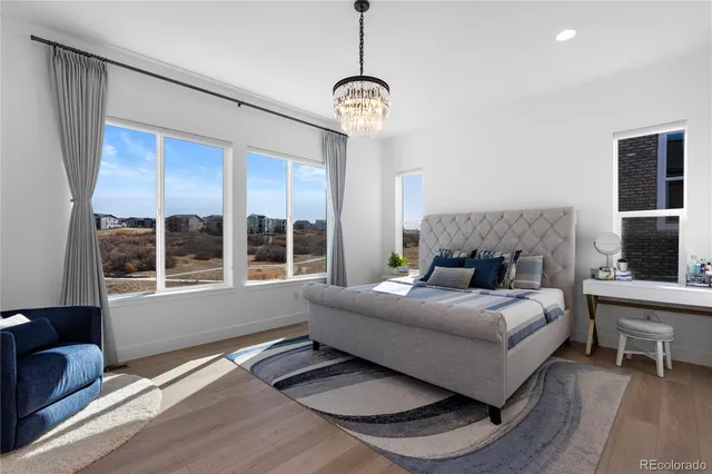 a living room with a bed furniture and a large window