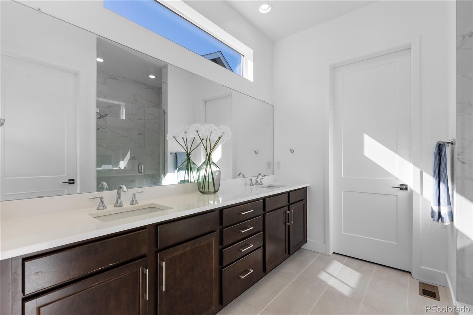 6610 Fawn Path Lane Castle Pines, CO 80108 - Photo 29 of 50 a bathroom with a double vanity sink and mirror