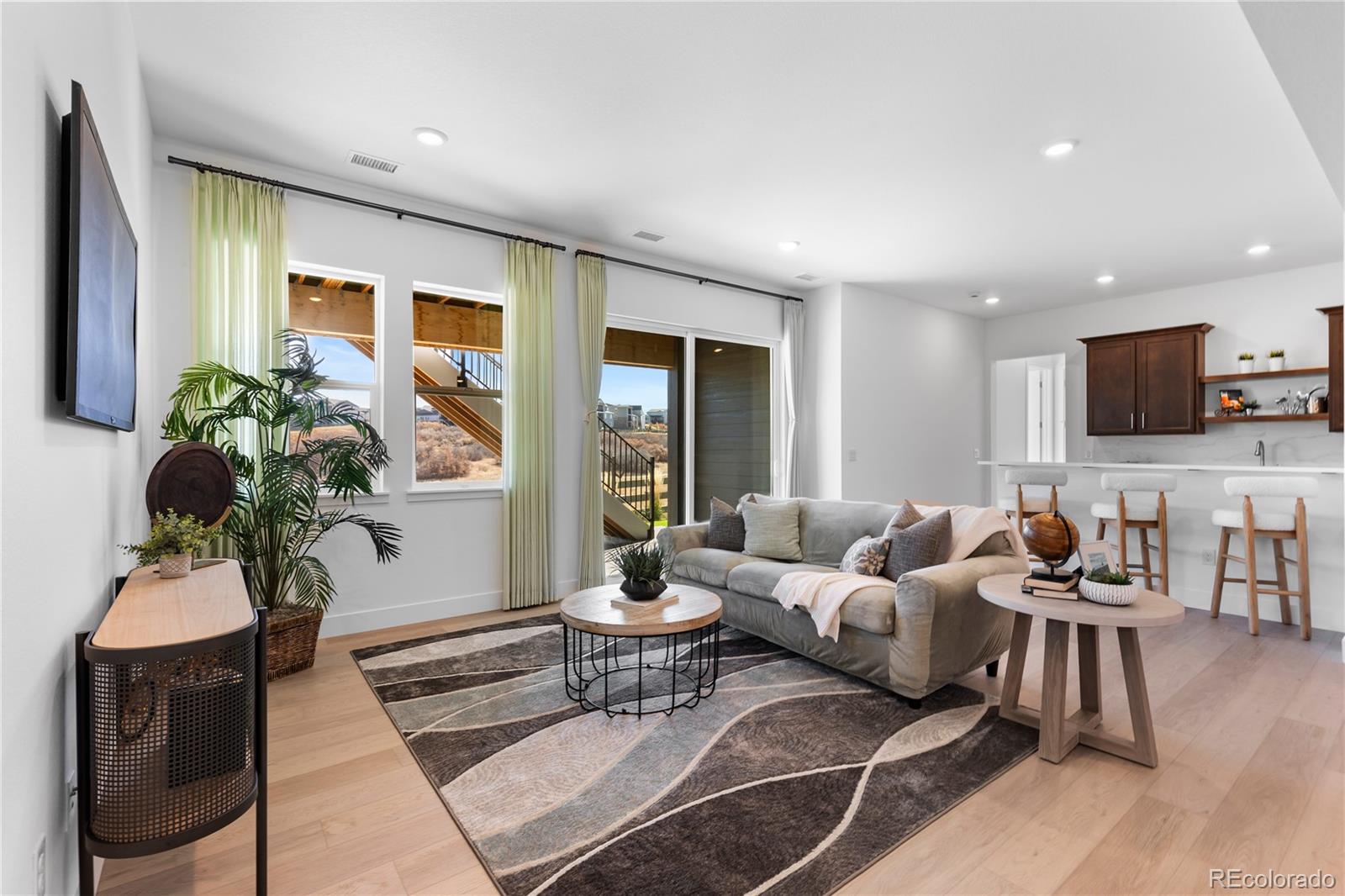 6610 Fawn Path Lane Castle Pines, CO 80108 - Photo 32 of 50 a living room with furniture and a flat screen tv