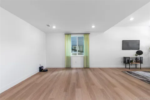 a hallway with a couch and a flat screen tv