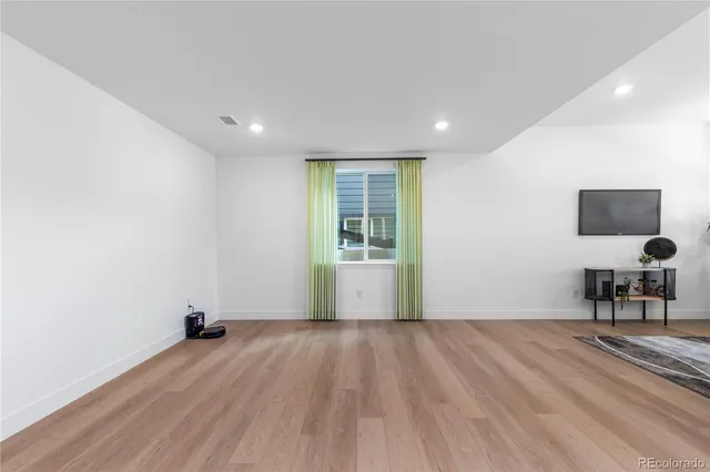 a hallway with a couch and a flat screen tv