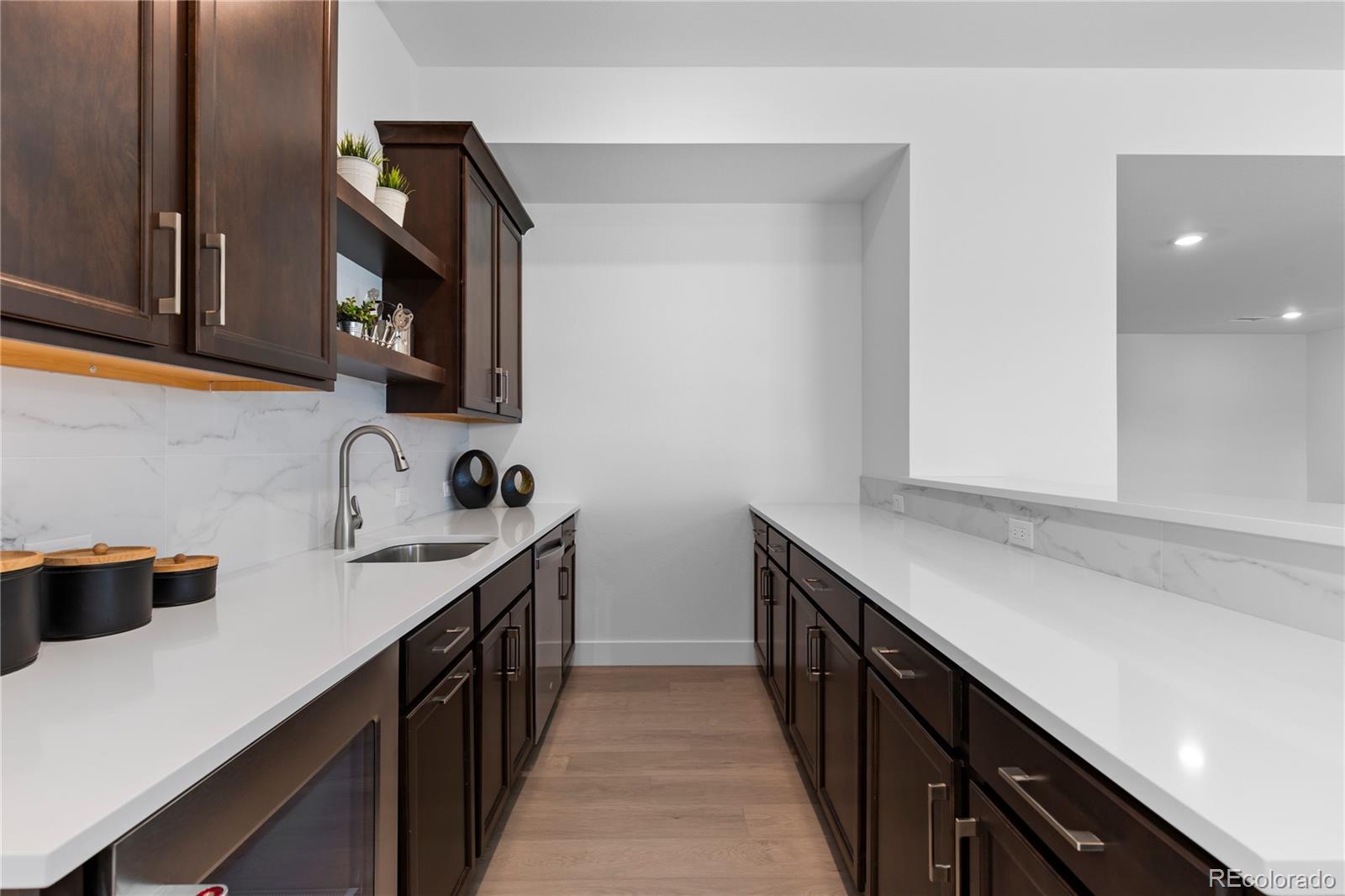 6610 Fawn Path Lane Castle Pines, CO 80108 - Photo 38 of 50 a kitchen with a sink and a stove top oven