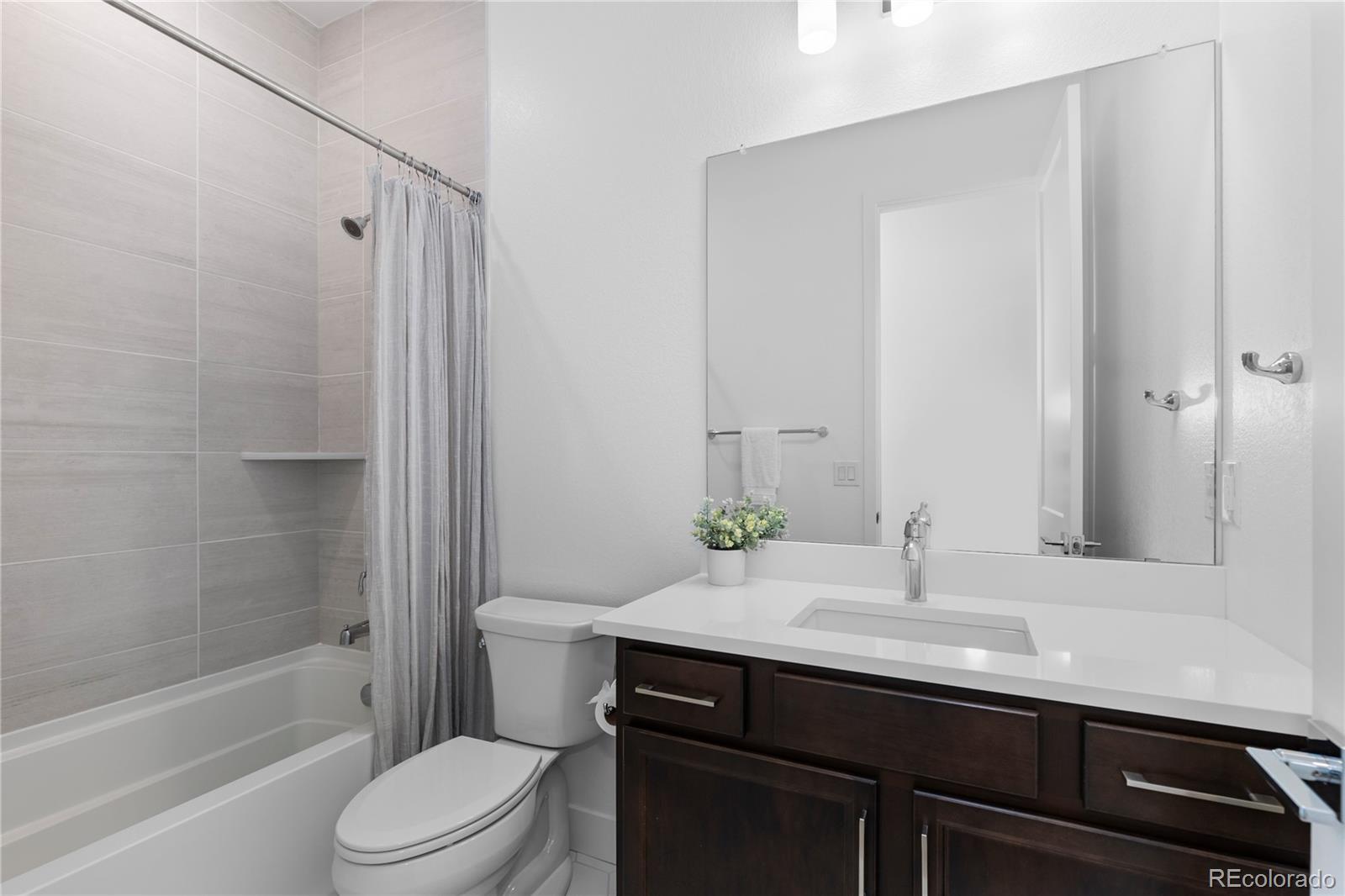 6610 Fawn Path Lane Castle Pines, CO 80108 - Photo 43 of 50 a bathroom with a sink a toilet and shower