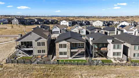 a view of a house with wooden deck and furniture