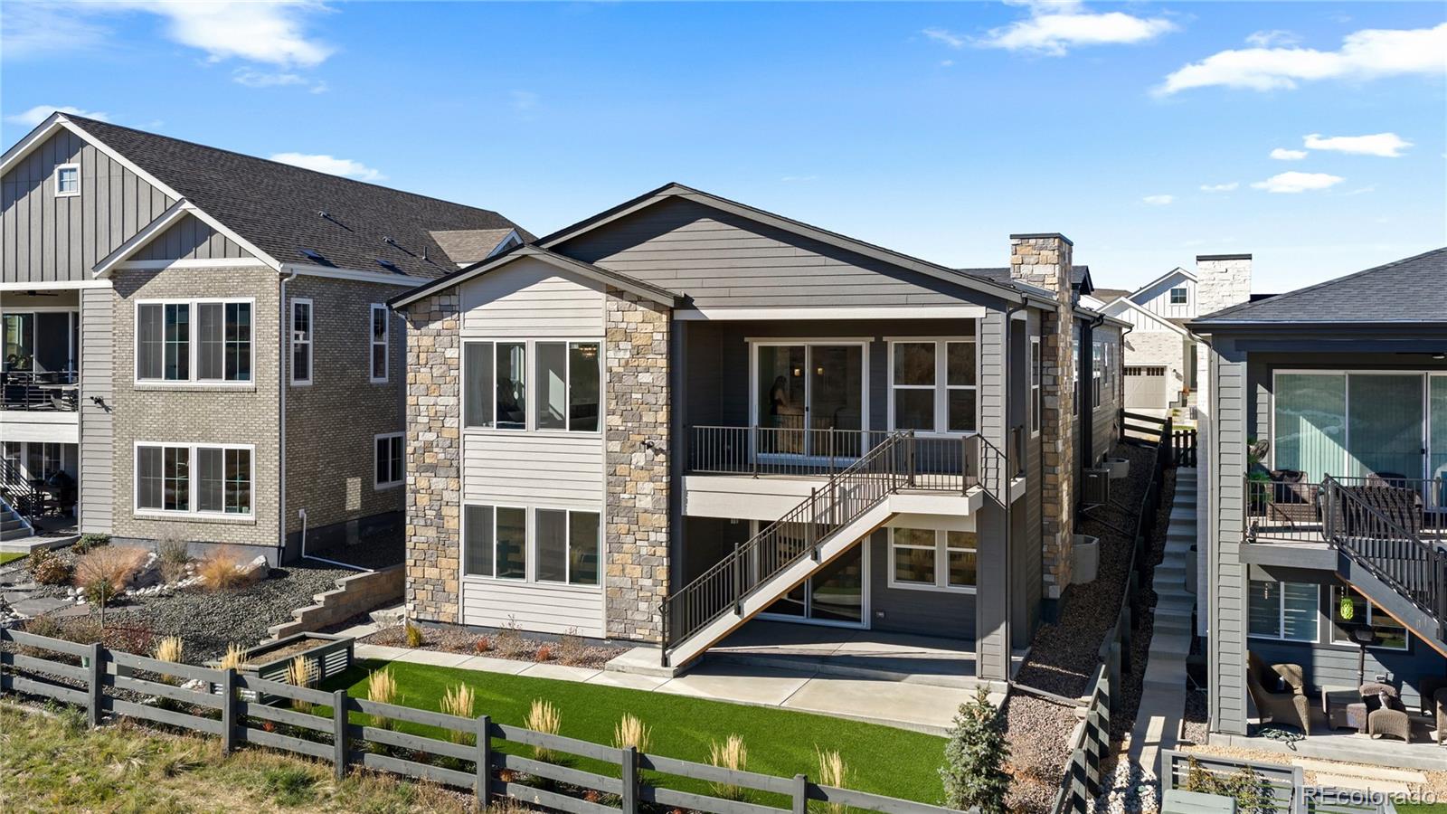 6610 Fawn Path Lane Castle Pines, CO 80108 - Photo 48 of 50 a view of a house with wooden deck and furniture