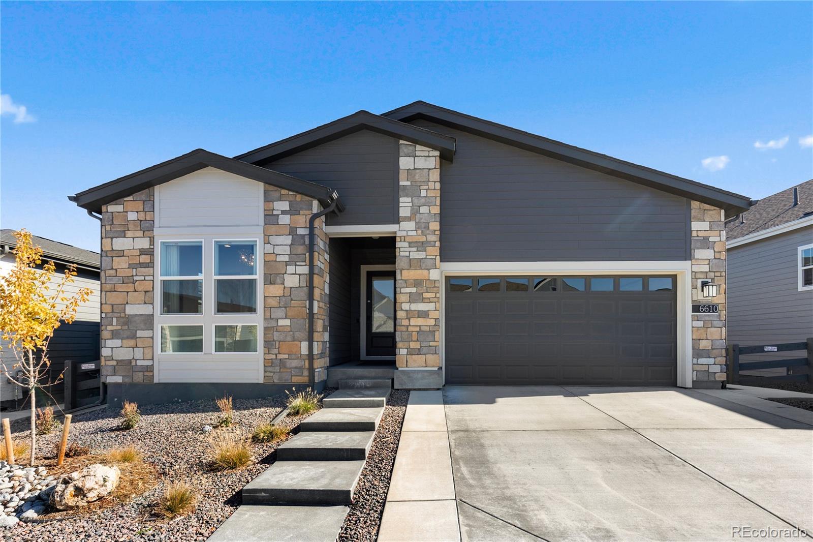 6610 Fawn Path Lane Castle Pines, CO 80108 - Photo 49 of 50 a front view of a house with a yard
