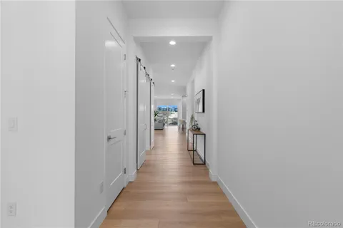 a view of a hallway with a wooden floor