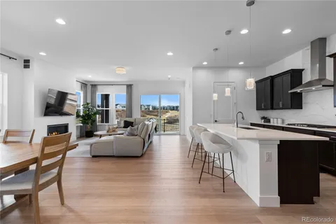 a living room with furniture and kitchen view