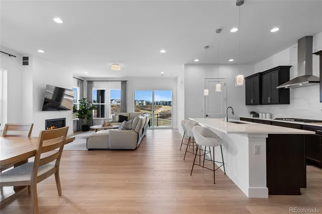 a living room with furniture and kitchen view