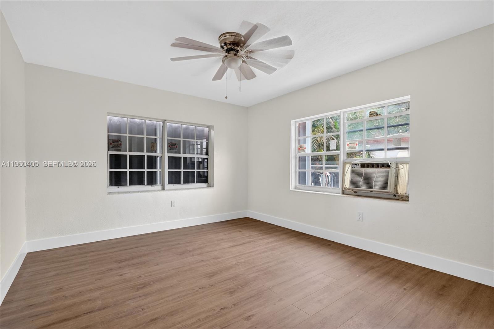 280 Northwest 34th Street Miami, FL 33127 - Photo 13 of 34 a view of an empty room with wooden floor and a window