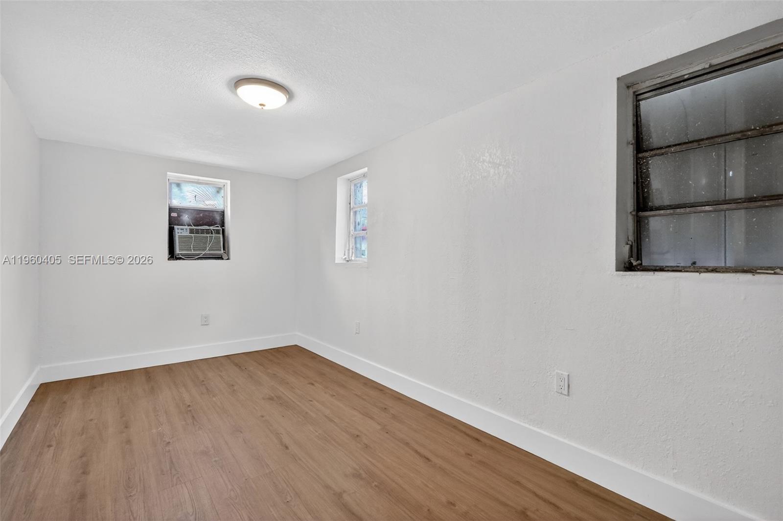 280 Northwest 34th Street Miami, FL 33127 - Photo 17 of 34 an empty room with a mirror and a window