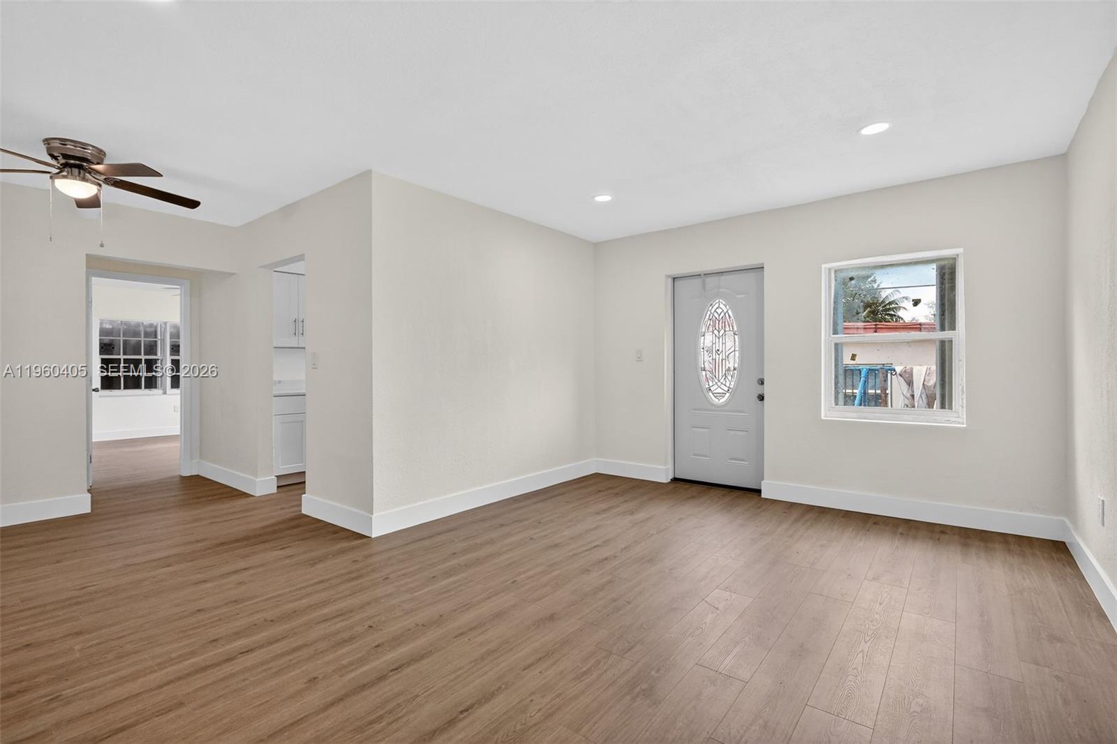 280 Northwest 34th Street Miami, FL 33127 - Photo 3 of 34 a view of an empty room with wooden floor and a window