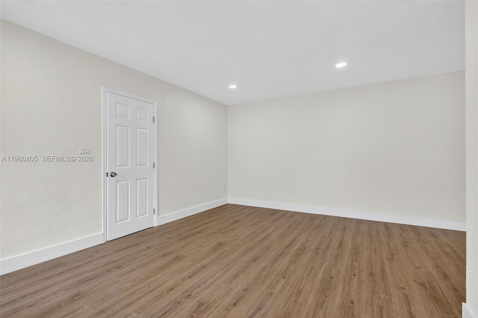 280 Northwest 34th Street Miami, FL 33127 - Photo 4 of 34 a view of an empty room with wooden floor