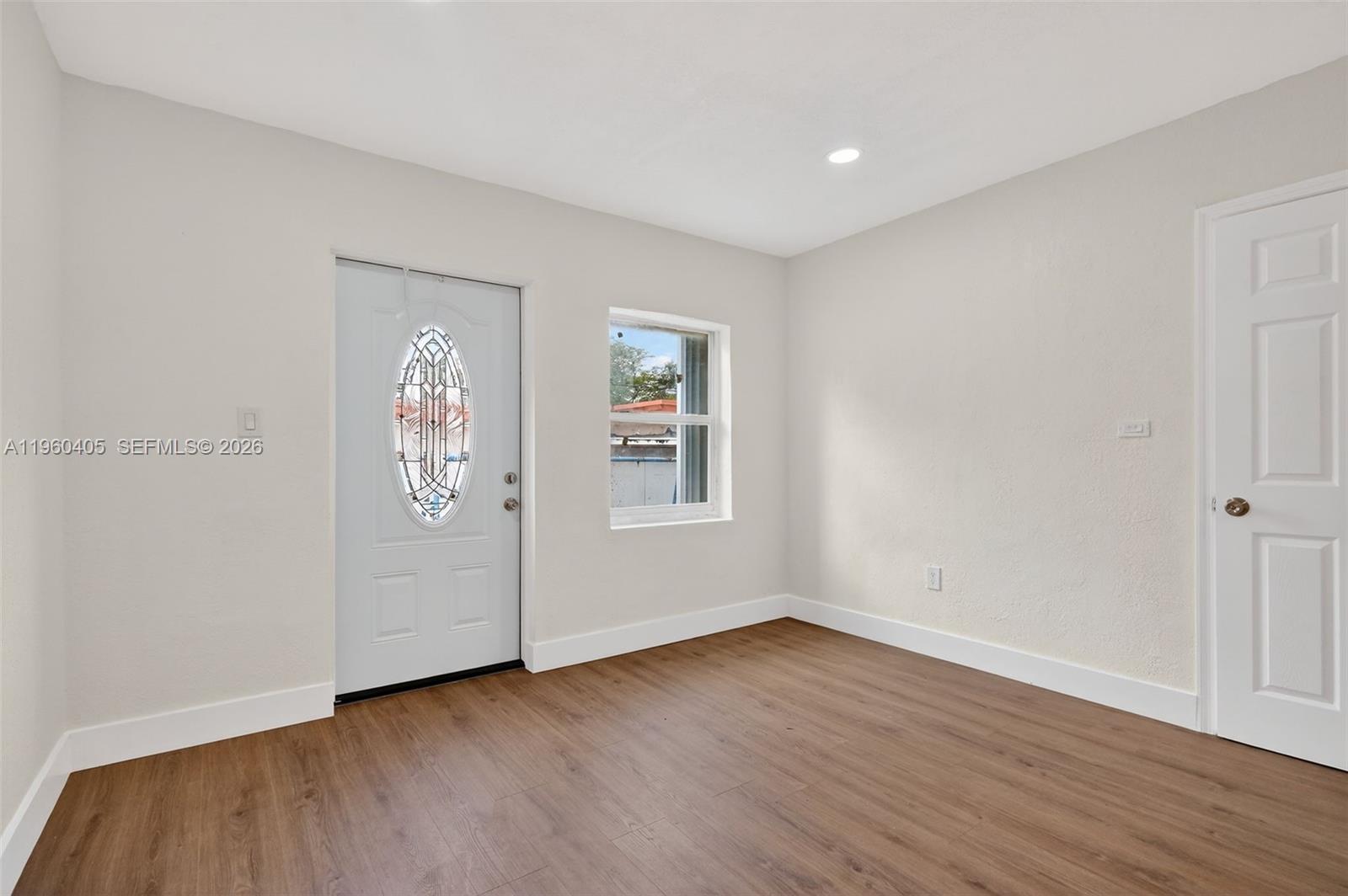 280 Northwest 34th Street Miami, FL 33127 - Photo 6 of 34 an empty room with wooden floor and window