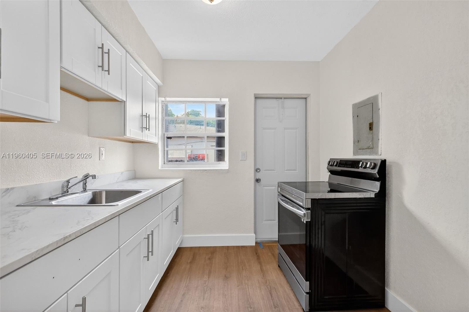280 Northwest 34th Street Miami, FL 33127 - Photo 9 of 34 a kitchen with a sink and wooden floor
