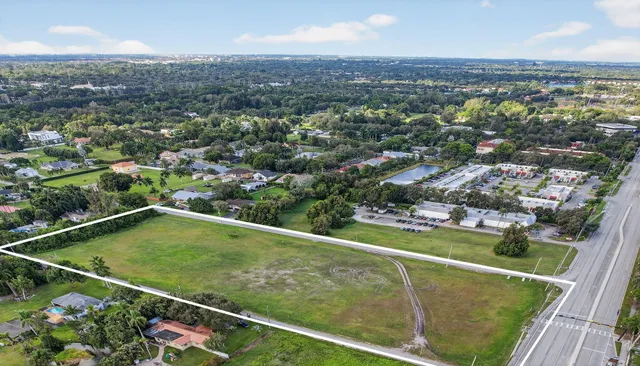 an aerial view of residential houses with outdoor space and swimming pool