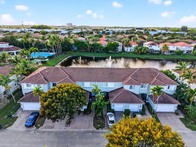 an aerial view of a house with a garden and lake view