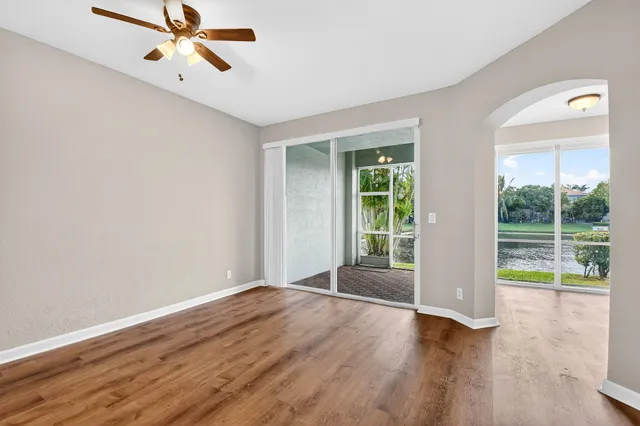 a kitchen with stainless steel appliances granite countertop a refrigerator oven a sink with wooden cabinets and floors