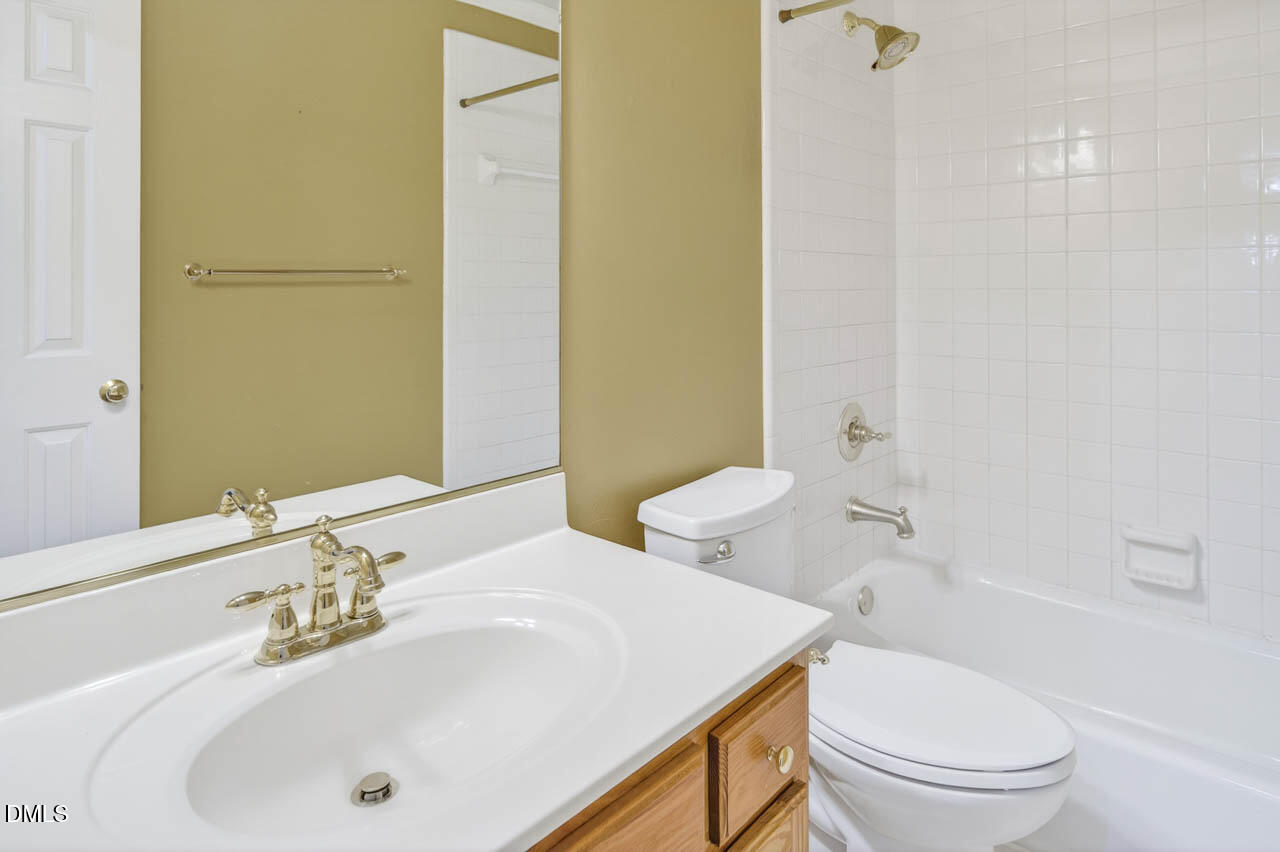 2209 Lodestar Drive Raleigh, NC 27615 - Photo 37 of 50 a bathroom with a sink a toilet and shower