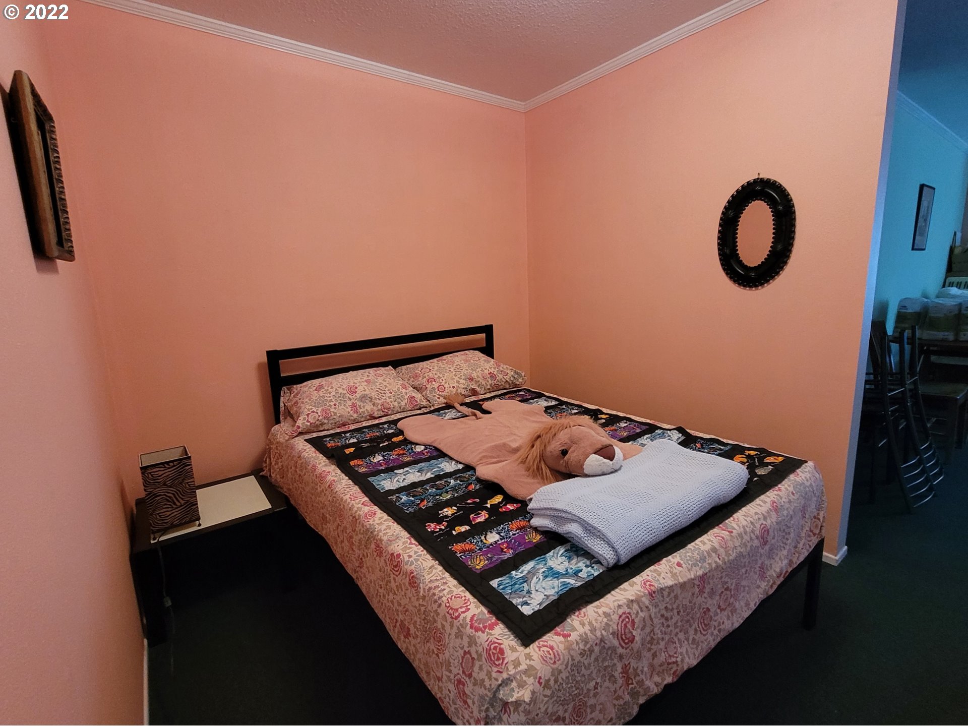 246 6th Street Port Orford, OR 97465 - Photo 13 of 34 a bed sitting in a bedroom next to a window