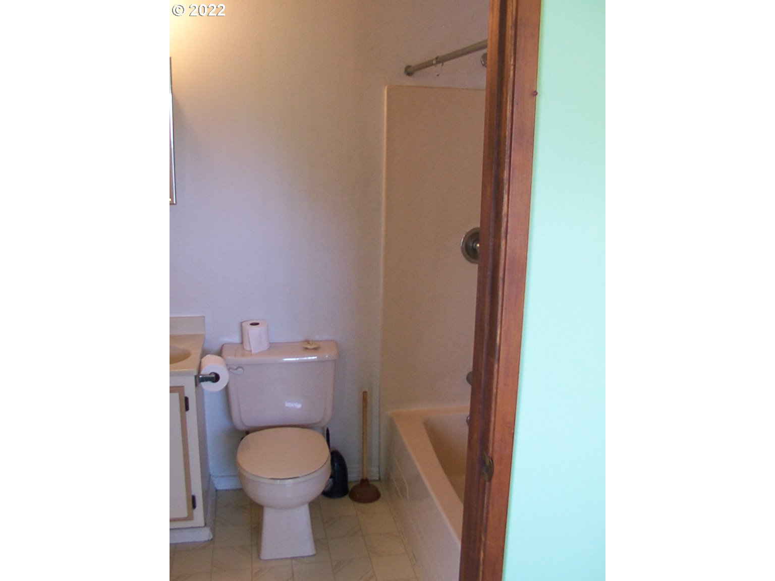 246 6th Street Port Orford, OR 97465 - Photo 21 of 34 a bathroom with a toilet a sink and a mirror