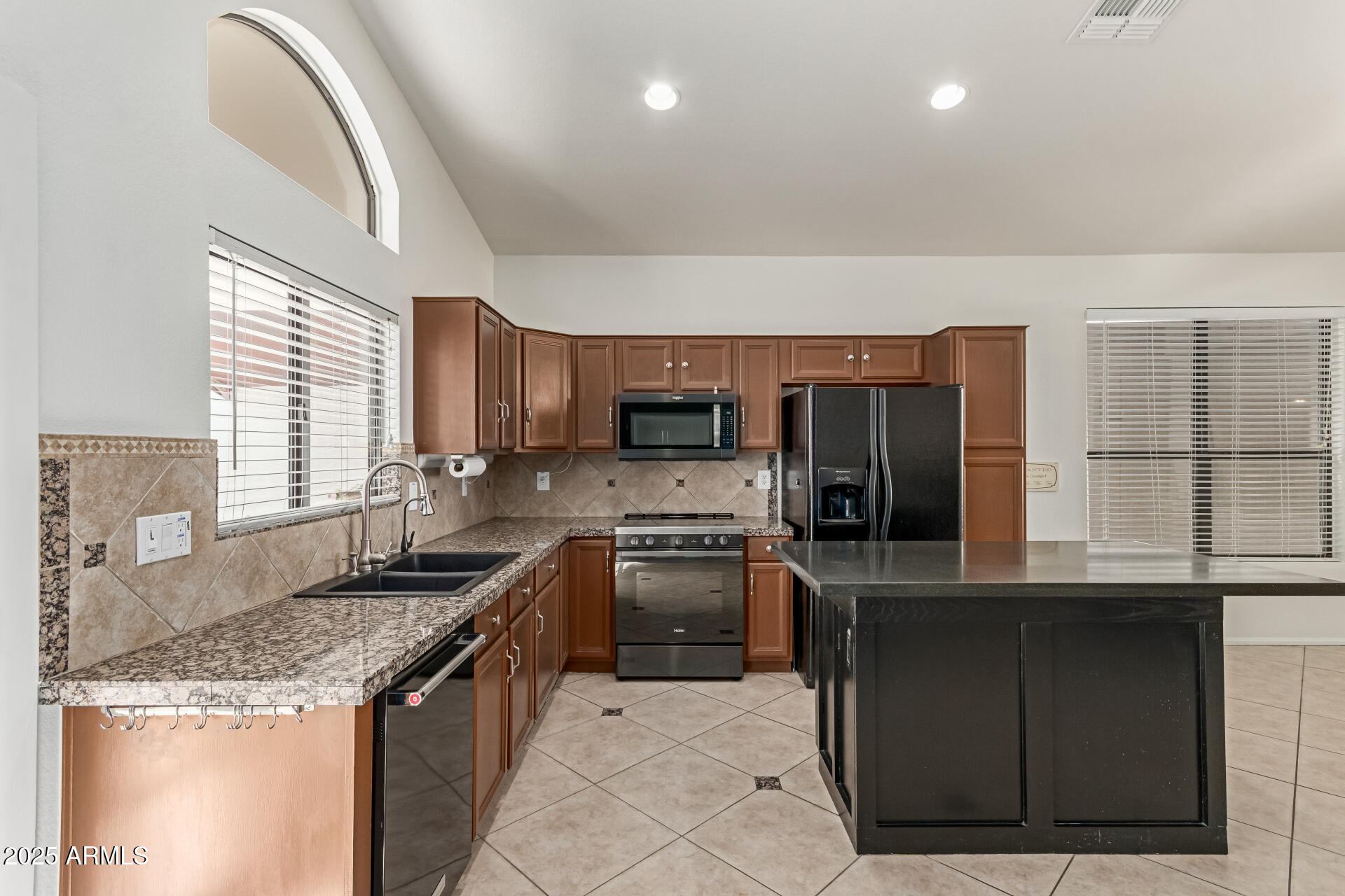 2107 East Marco Polo Road Phoenix, AZ 85024 - Photo 12 of 36 a kitchen with stainless steel appliances granite countertop a stove a sink and a microwave