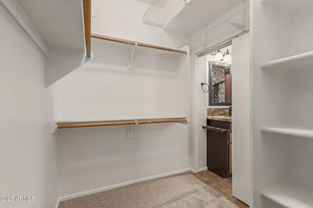 a view of walk in closet with empty racks