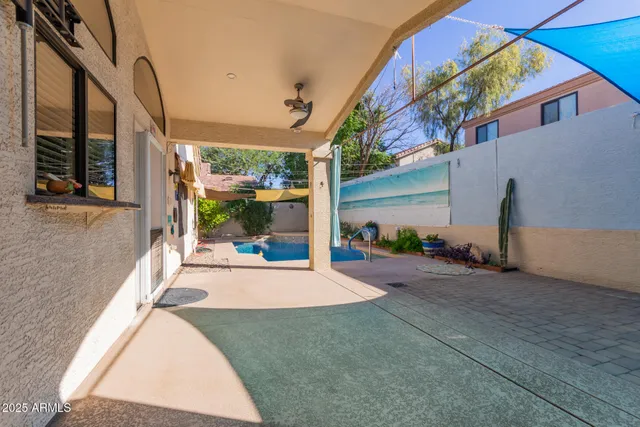 a view of a house with a porch and furniture